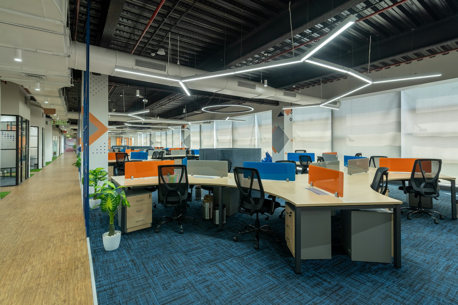 A modern open-plan office floor with rows of desks